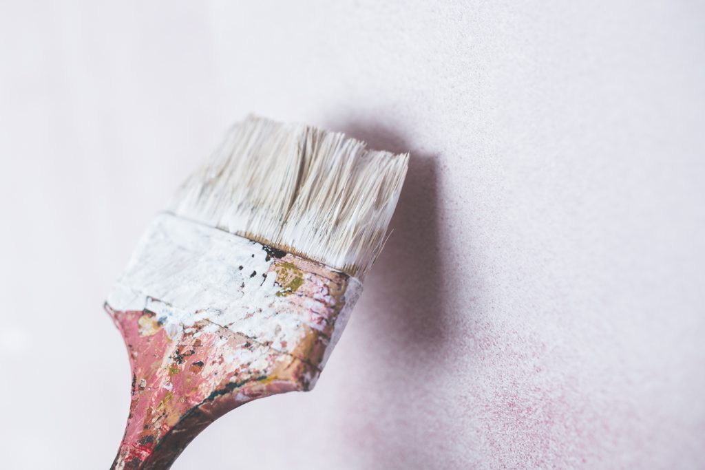 paint brush against a wall