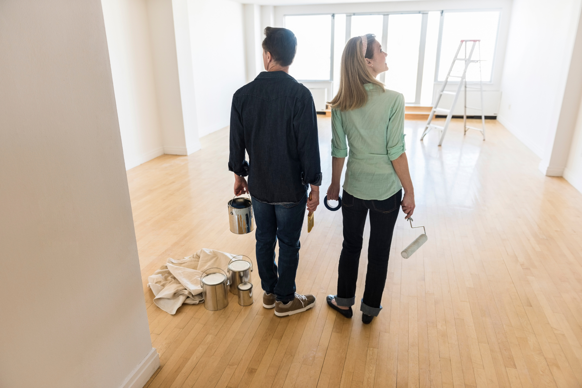 two people about to paint walls