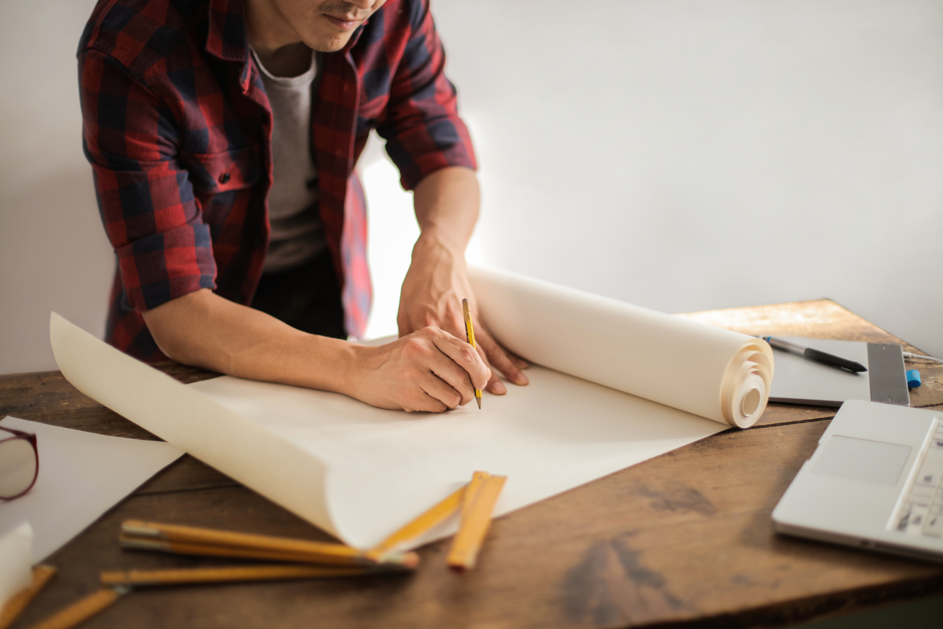 man writing on project paper